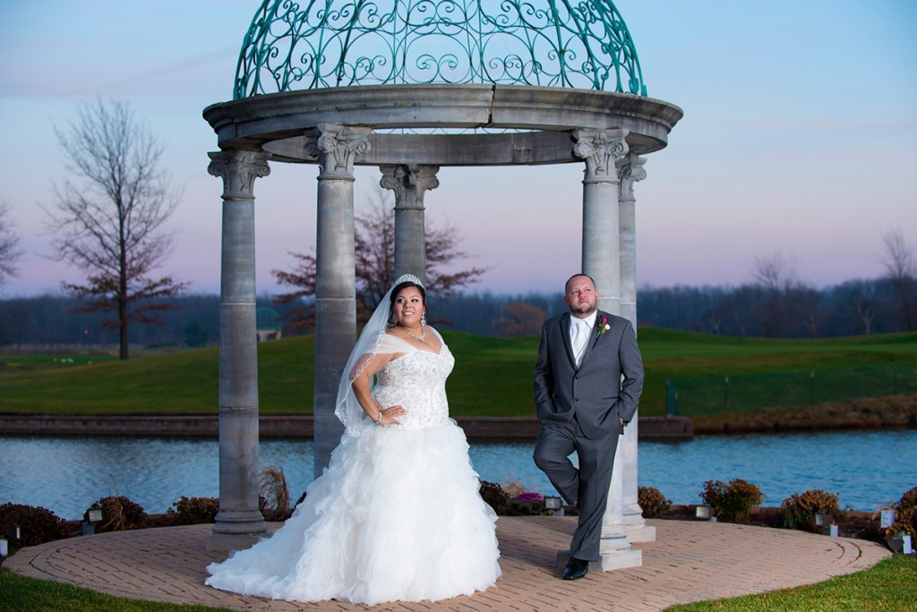 Bride and groom in front of the gazebo at sunset.