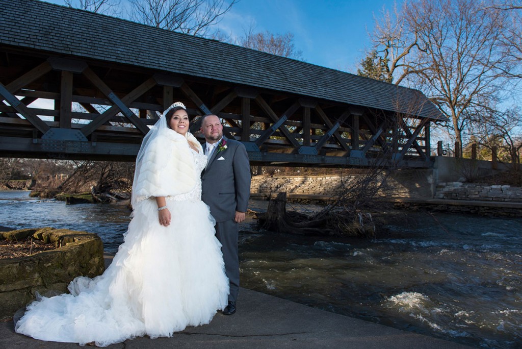 Bride and groom on sunny day in front of wooden bridge naperville.