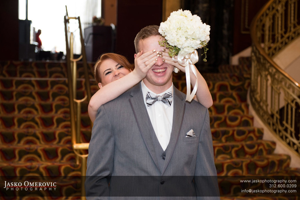 Bride covering grooms eyes for a first look in Chicago Wedding