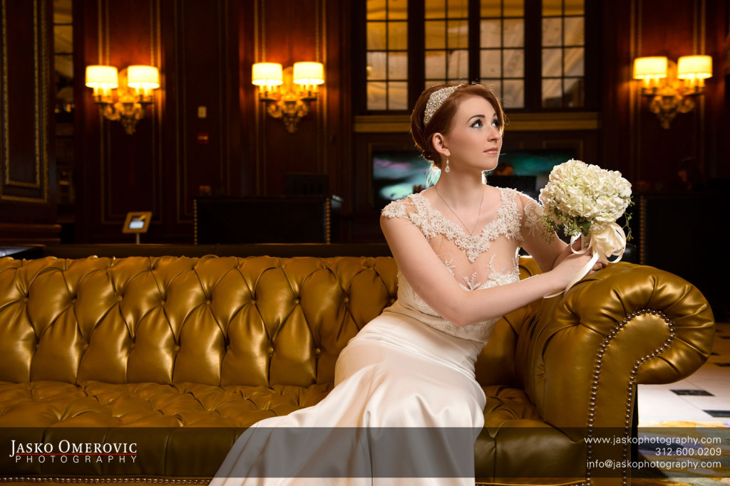 Beauty portrait of a bride sitting on a golden couch in blackstone hotel Chicago