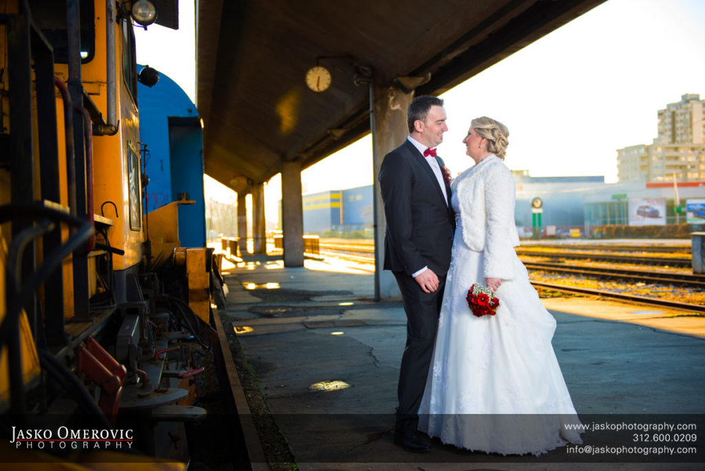 Bride and groom at the train station with clock in the background