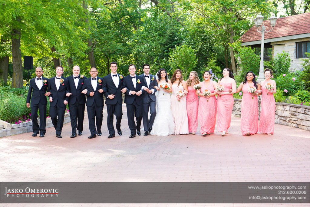 whole bridal party of 14 walking towards the camera