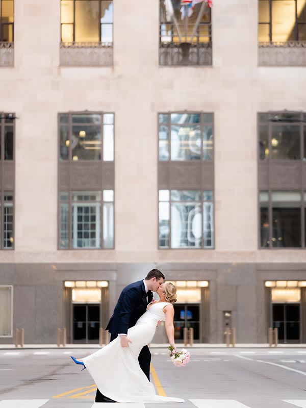 bride and groom kissing in the middle of chicago street
