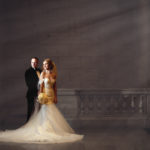 bride and groom at the union station with light entering the building