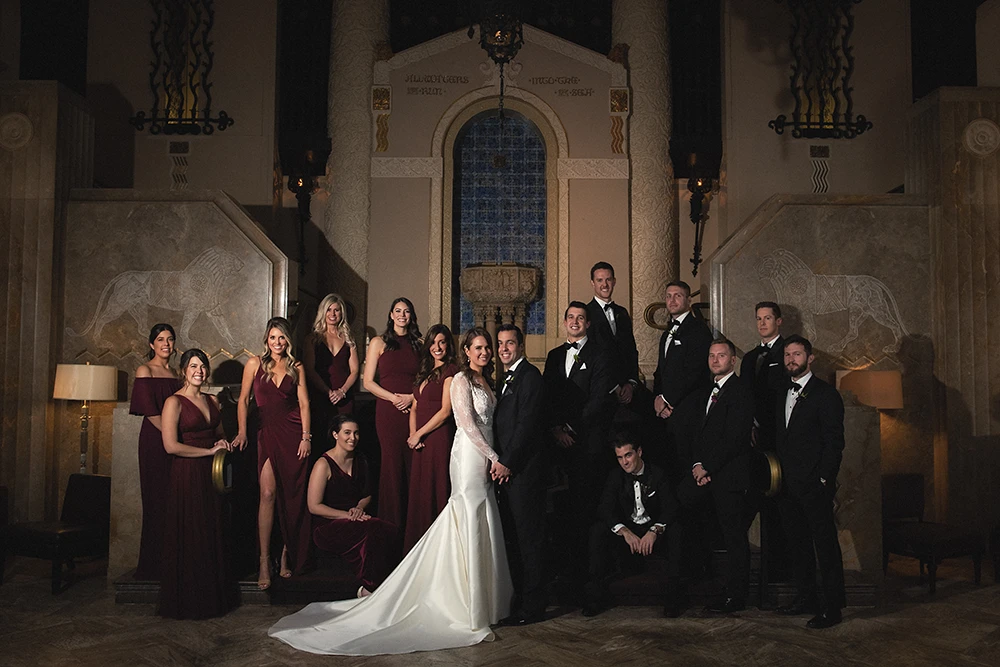 vanity fair style wedding party portrait at a roman looking room