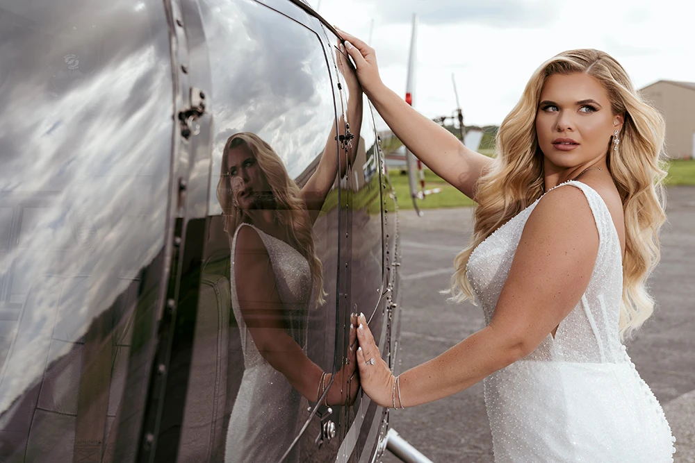 high end portrait of a bride with window reflection and wind in her hair, high end makeup