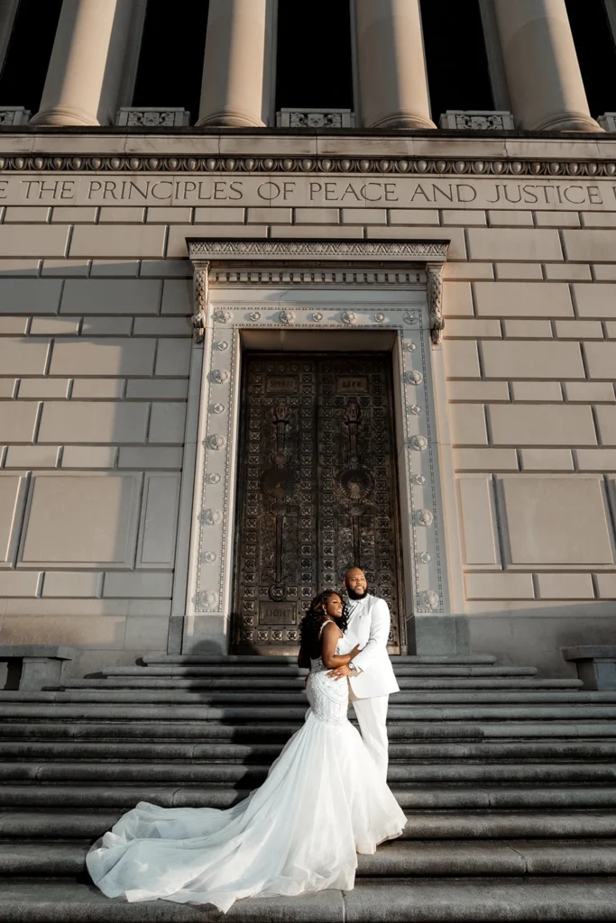 wedding couple portrait framed within the architectural lines, pillars and heavy front gate