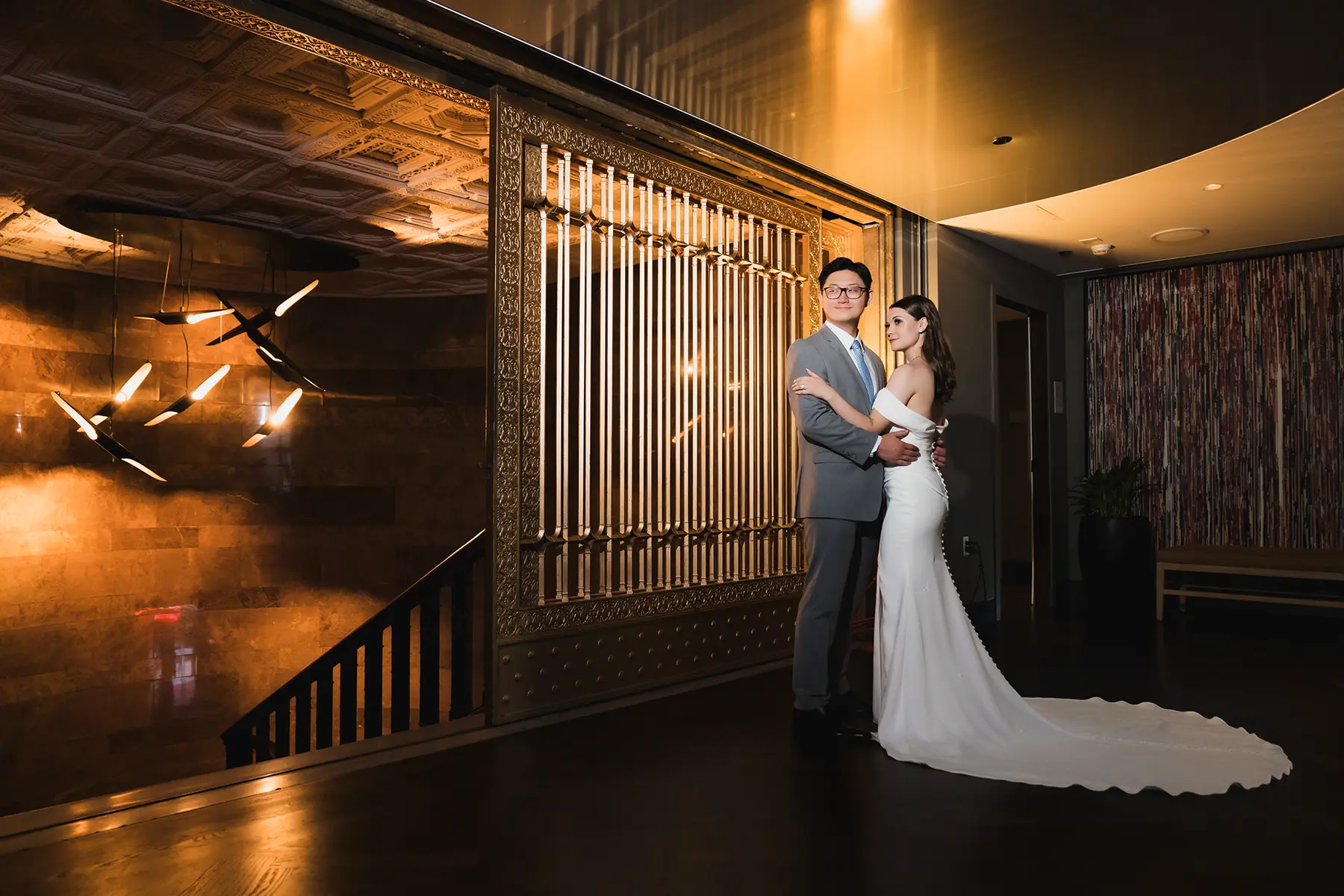 Bride and groom photographed inside a grand downtown Chicago hotel during their wedding, showcasing elegant interiors and architectural scale