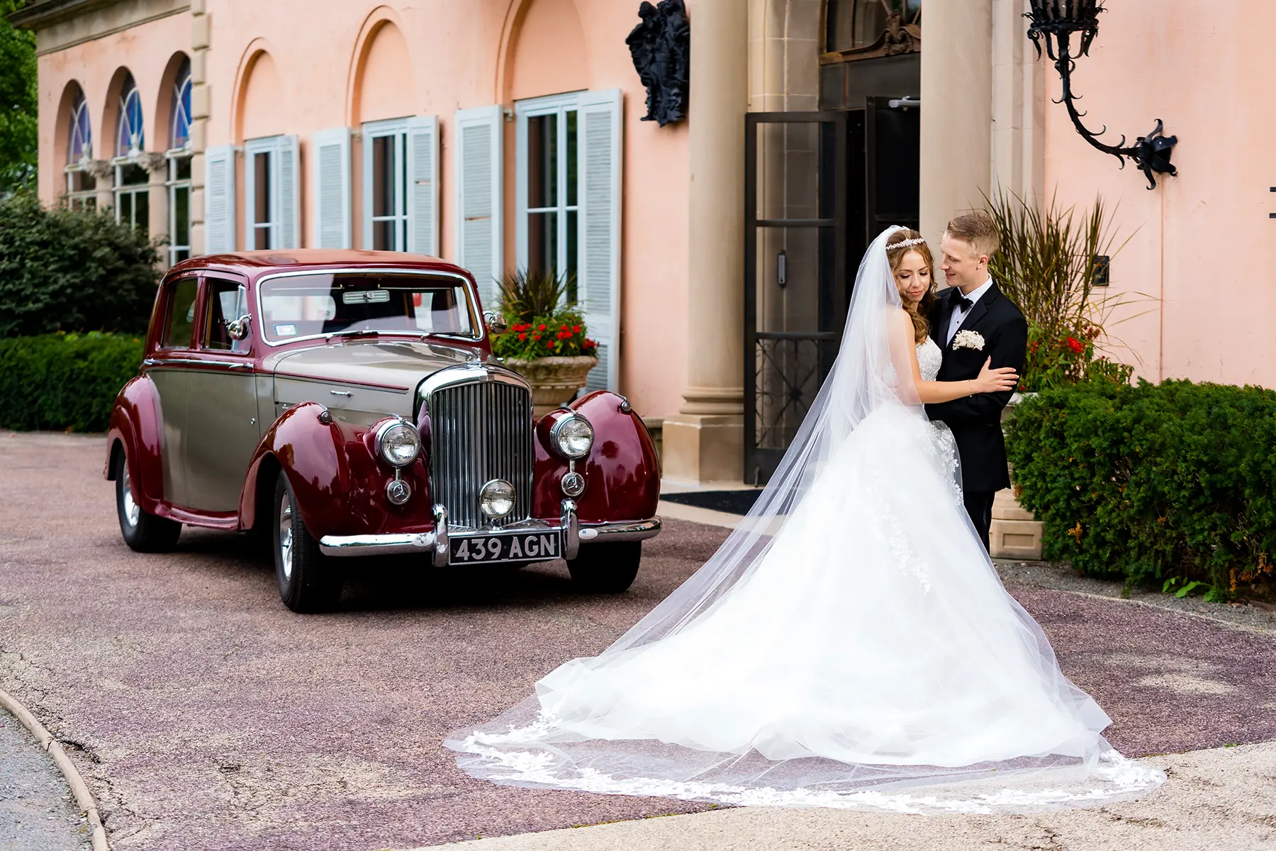 Bride and groom photographed at Cuneo Mansion during their wedding, surrounded by historic estate architecture and formal interiors