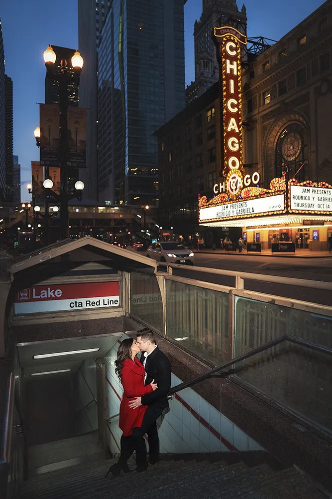 couple kissing by chicago theater sign in the dark