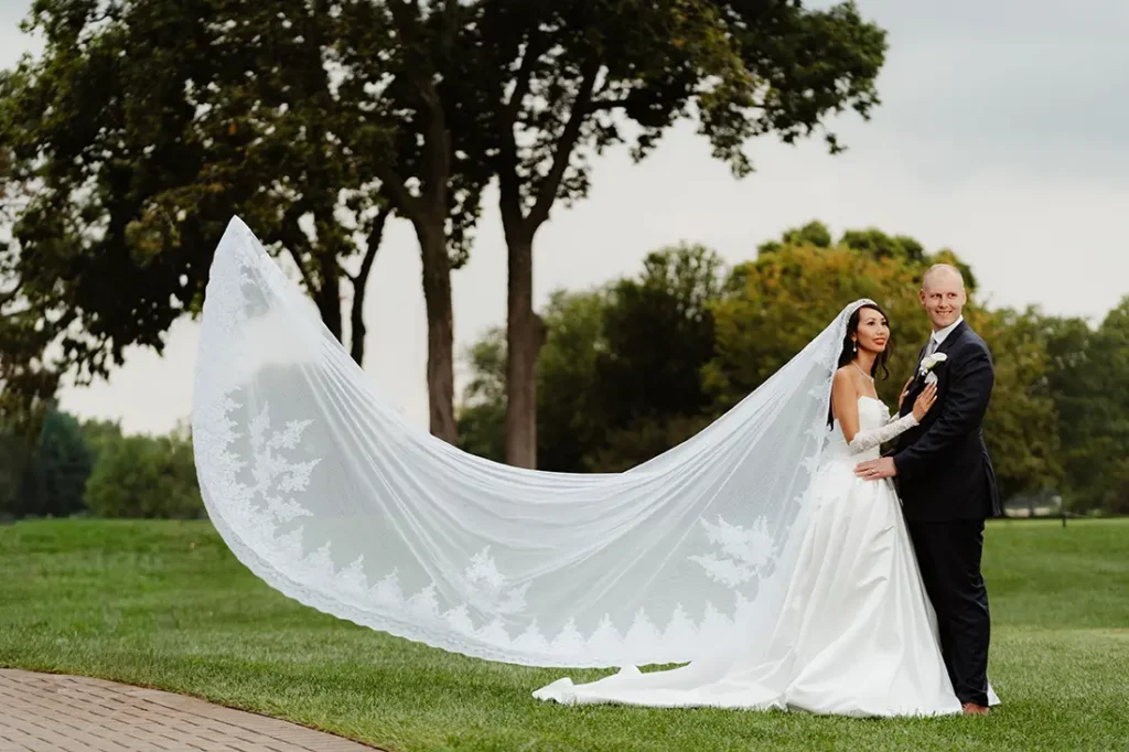 bride and groom sunset ridge club wedding portrait with flying veil in the wind